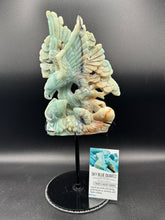 Load image into Gallery viewer, Carved stone sculpture of a bird on a stand with a label in the background