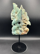 Load image into Gallery viewer, Carved stone sculpture of a dragon on a black stand against a dark background

