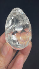 Load and play video in Gallery viewer, Brazilian Clear quartz flame Clarity faceted egg ZB21 with crystal info card
